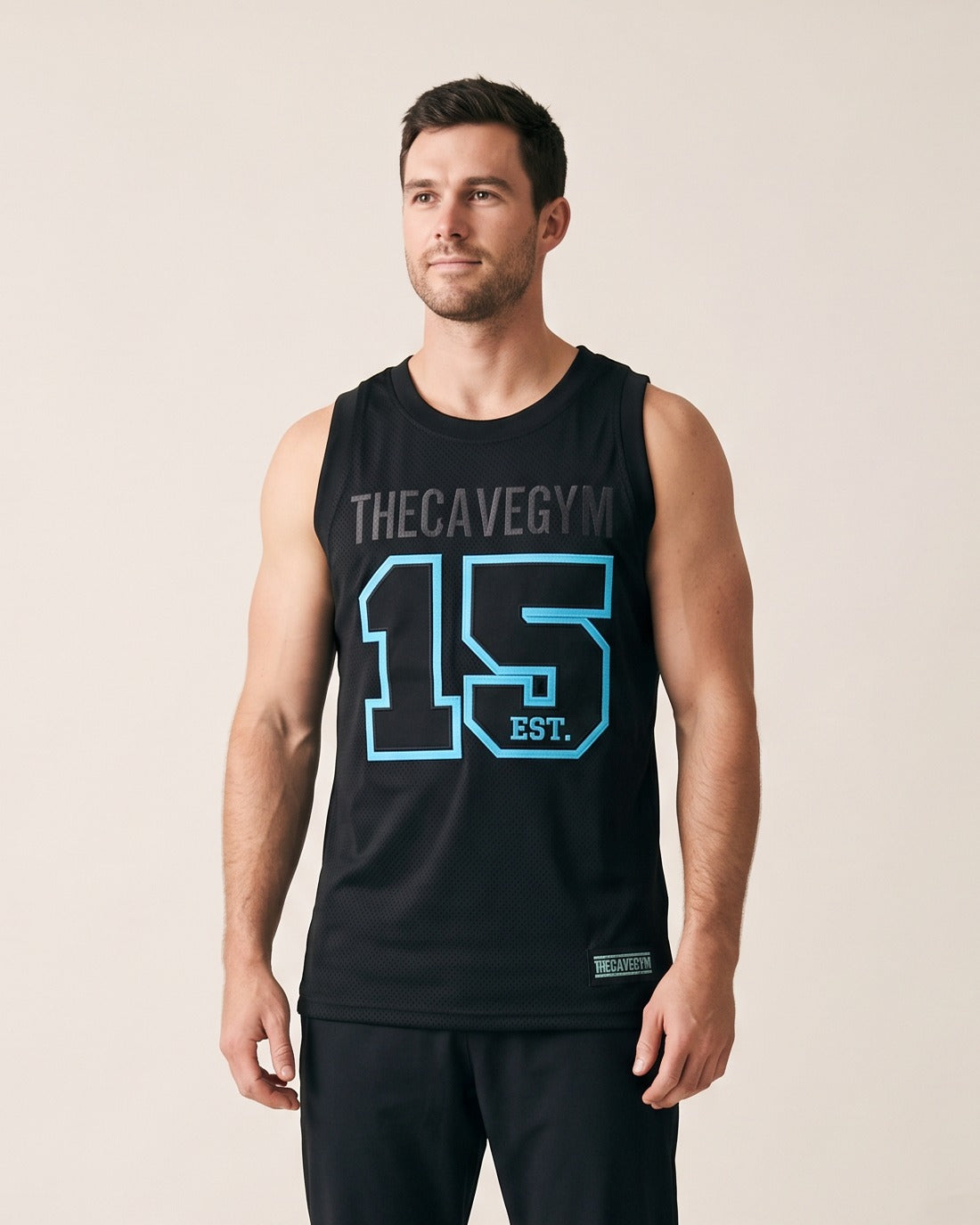 Basketball Jersey (Embroidered) by The Cave Gym worn by model